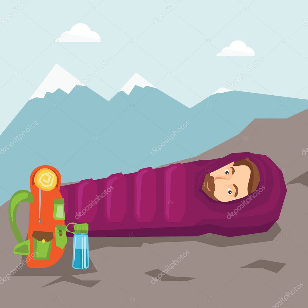 Man sleeping in sleeping bag in the mountains.