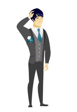 Genç Asyalı damat başını tırmalamak.