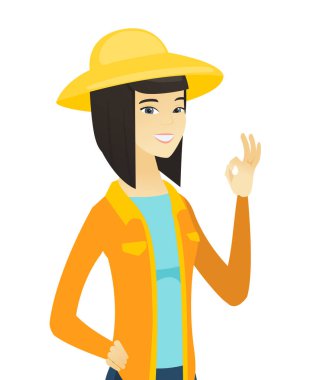 Ok işaret gösteren genç Asyalı çiftçi.