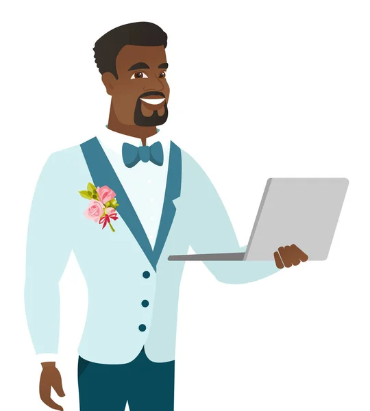Jovem noivo afro-americano usando um laptop . — Vetor de Stock
