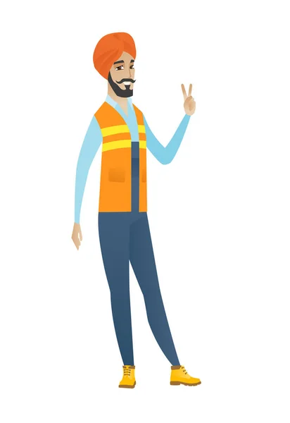 Young hindu builder showing victory gesture. — Stock Vector