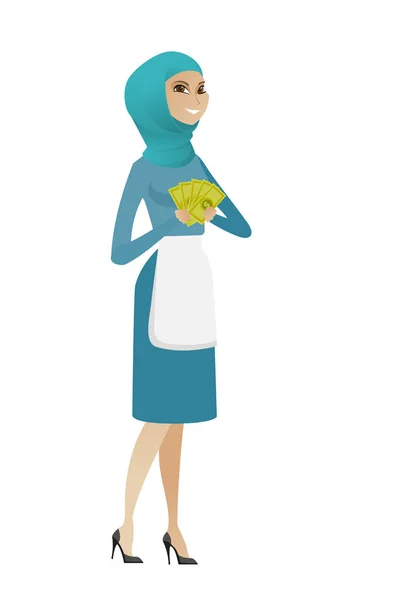 Young muslim cleaner holding money. — Stock Vector