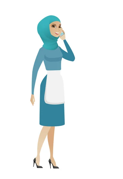 Young muslim cleaner talking on a mobile phone. — Stock Vector