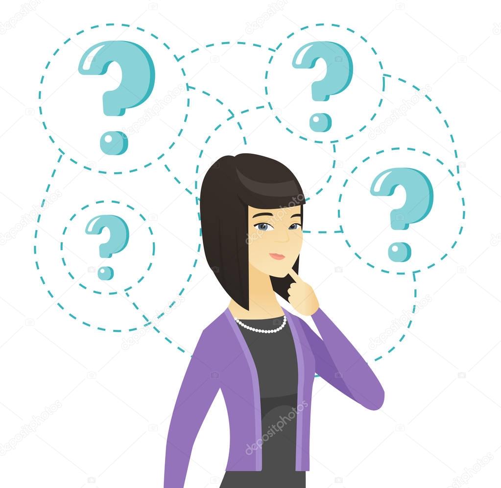 Young business woman standing under question marks