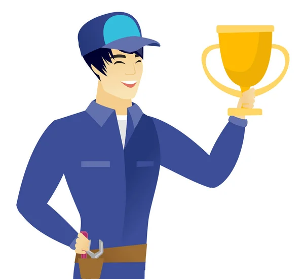 Young asian mechanic holding a trophy. — Stock Vector