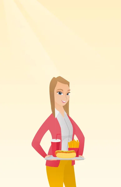 Woman holding tray full of fast food. — Stock Vector