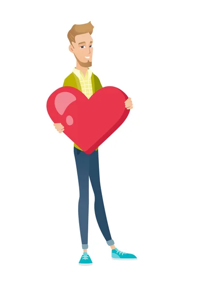 Hombre de negocios caucásico sosteniendo un gran corazón rojo . — Vector de stock