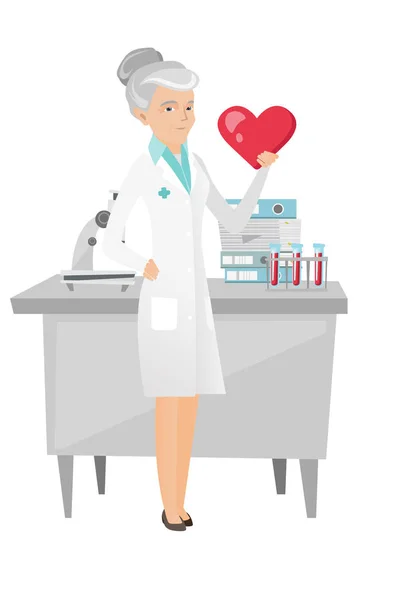Cardiologue caucasien tenant un grand cœur rouge . — Image vectorielle
