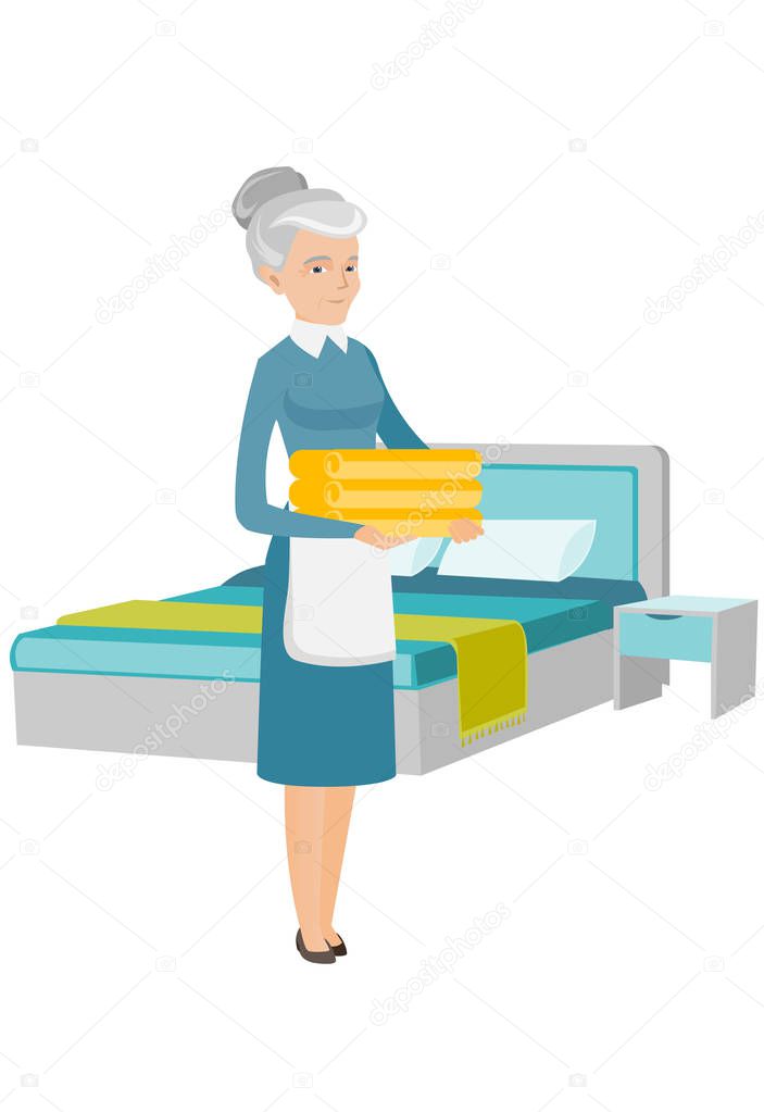 Caucasian housekeeping maid with stack of linen.