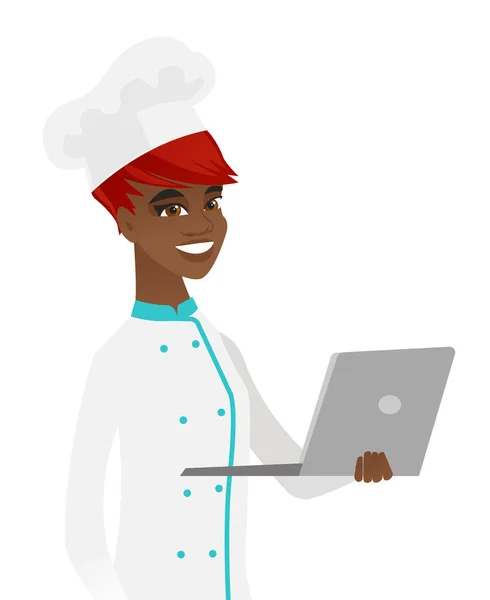 Jovem chef afro-americano usando um laptop . —  Vetores de Stock