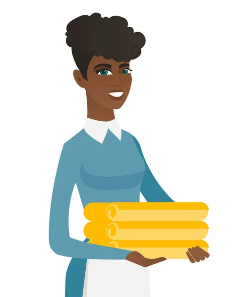 African housekeeping maid with stack of linen. — Stock Vector