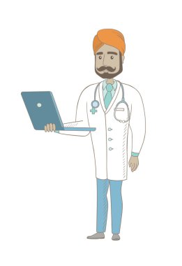 Bir dizüstü bilgisayar kullanarak genç Hint Doktor.