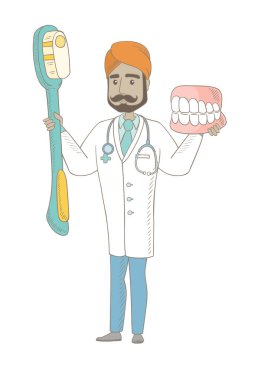 Dişçi diş çene modeli ve diş fırçası.