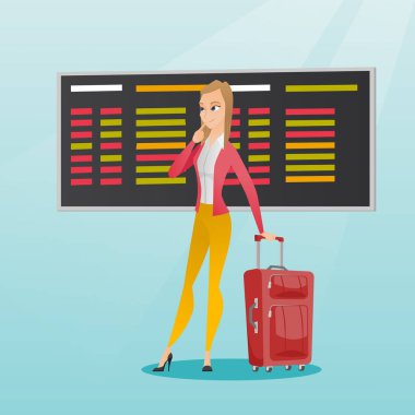 Kalkış panosu havaalanında arayan kadın.