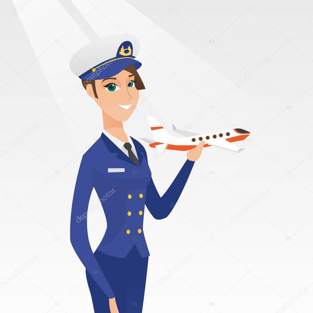 Cheerful airline pilot with the model of airplane.