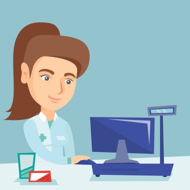 Bir eczane, bir bilgisayarda çalışan eczacı.