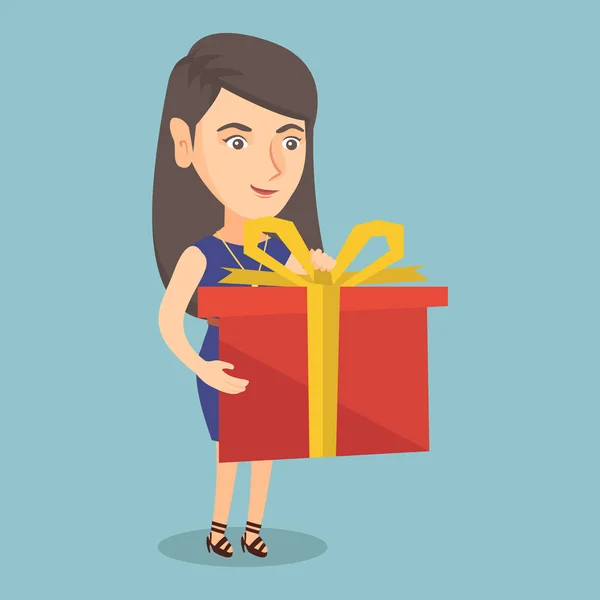 Young caucasian woman holding a box with gift. — Stock Vector