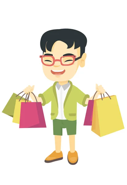 Feliz asiático chico holding compras bolsas . — Vector de stock