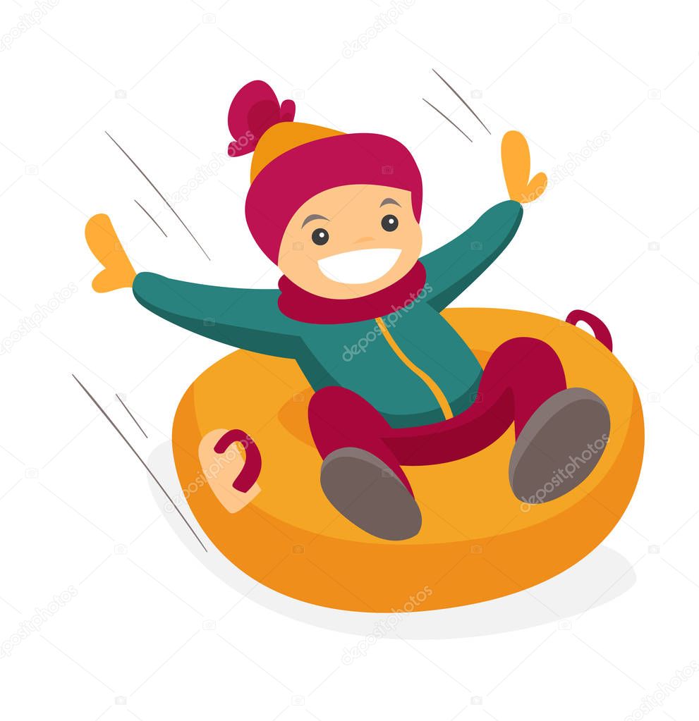 Caucasian boy sledding down on snow rubber tube.