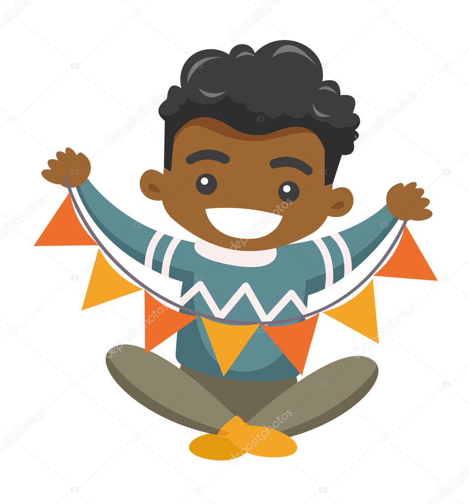 African boy holding a triangle holiday garland.