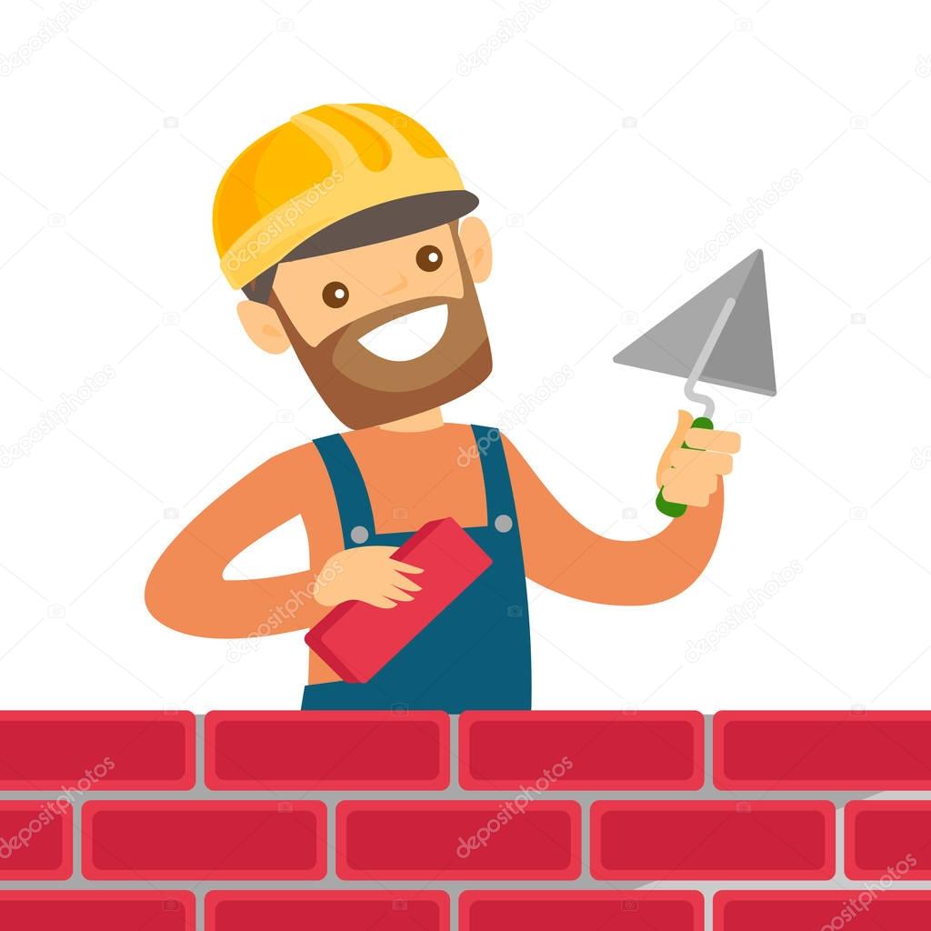 Caucasian white bricklayer building a brick wall.