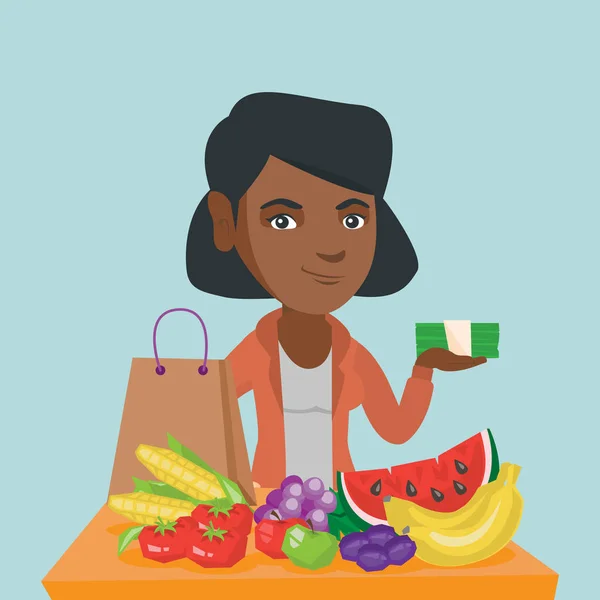 Mujer africana con dinero y compras de comestibles . — Vector de stock