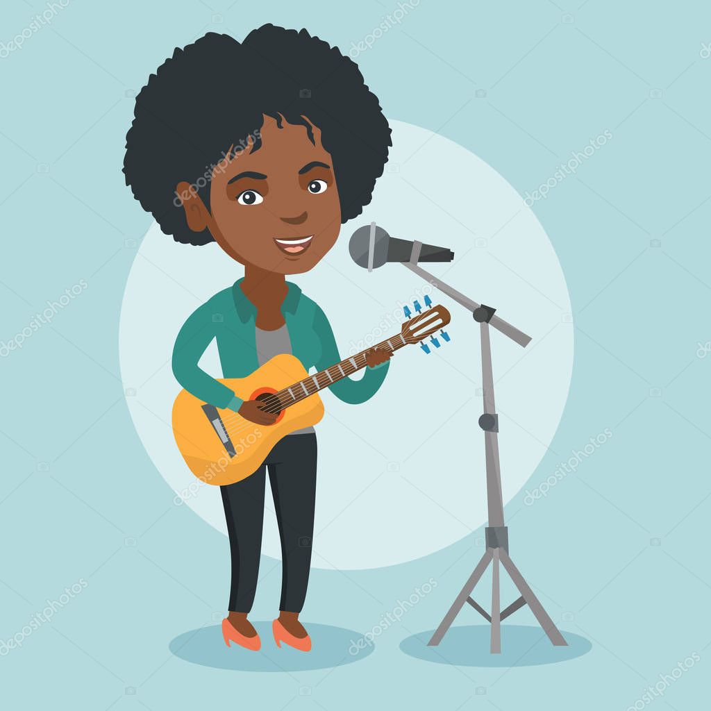 Woman singing into a mic and playing the guitar.