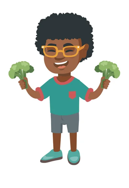 Piccolo ragazzo africano ridendo e tenendo broccoli — Vettoriale Stock