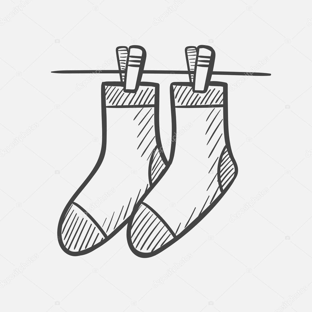 Socks on the clothesline hand drawn sketch icon.
