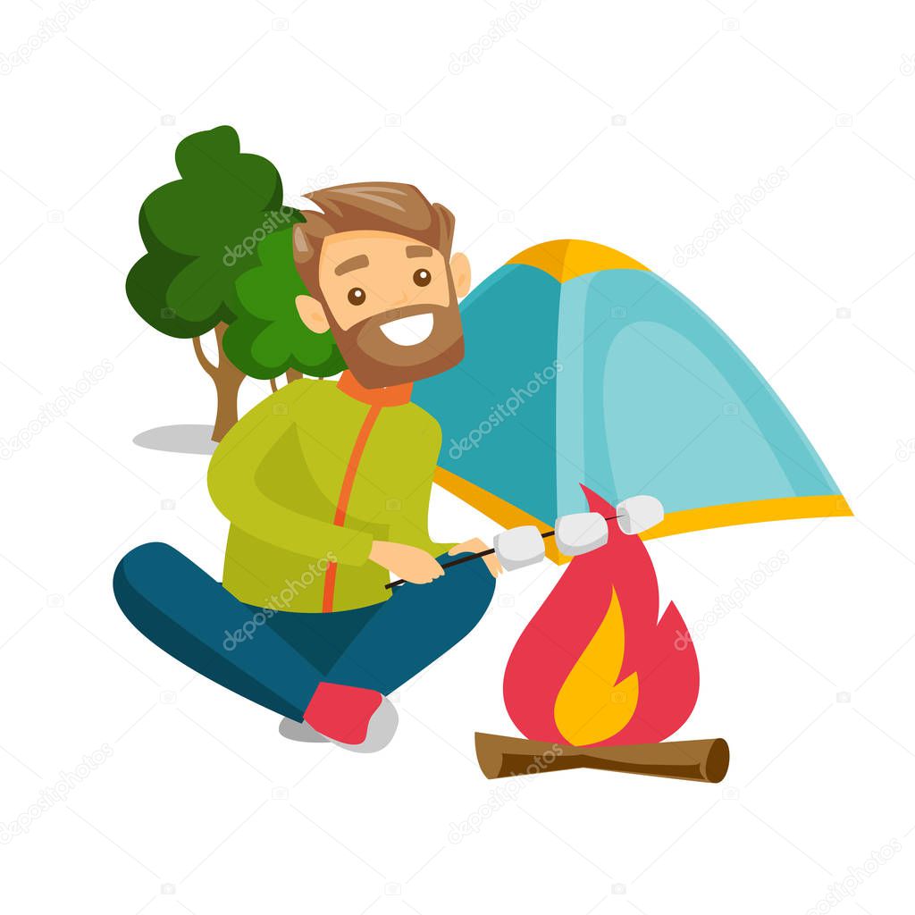 Caucasian man roasting marshmallow over campfire.