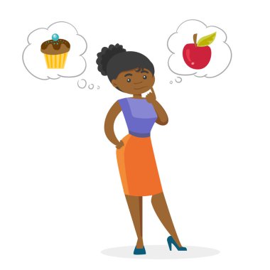 Afrikalı kadın elma ve cupcake arasında seçim yapma.