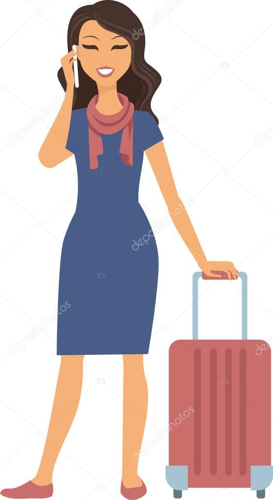 Young woman standing with suitcase and cell phone