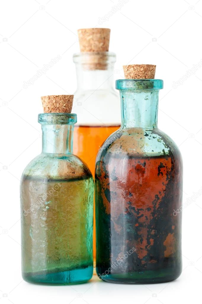 Three bottles of herbal infusion or essential oil closeup 