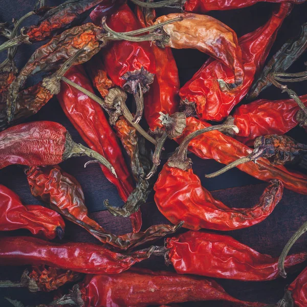 Red chili peppers on wooden board. Retro toned. — Stock Photo, Image