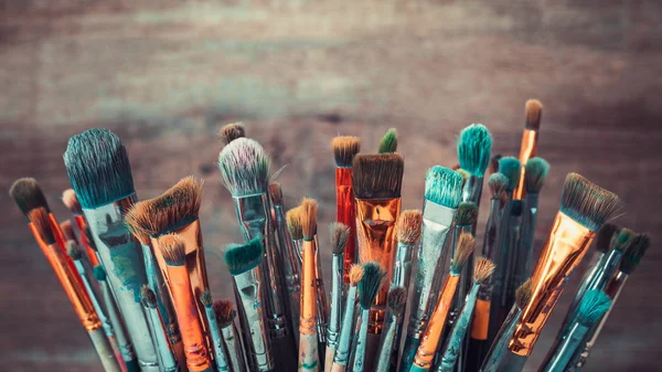 Bunch of artistic paintbrushes. Retro toned photo. — Stock Photo, Image