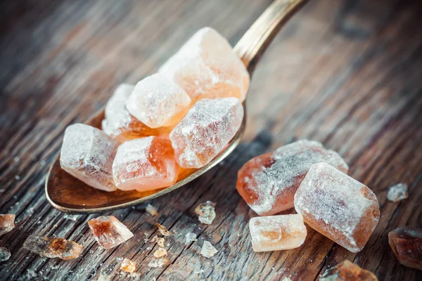 Caramelized brown cane sugar in spoon. — Stock Photo, Image