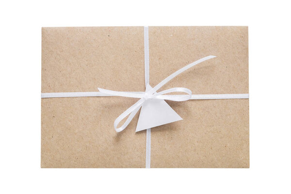 Envelope from craft paper decorated with ribbon and label. Isolated on white.