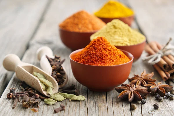 Aromatic spices and herbs: red pepper, turmeric, cardamom, cloves, anise, paprika. Ingredients for cooking. — Stock Photo, Image