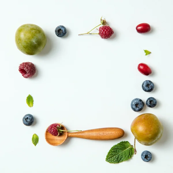 Autumn berries and wooden spoons — Stock Photo, Image