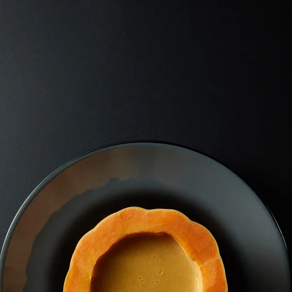 Pumpkin bowl on a black background — Stock Photo, Image