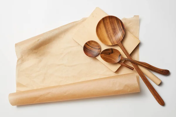 Wooden spoons on baking paper — Stock Photo, Image