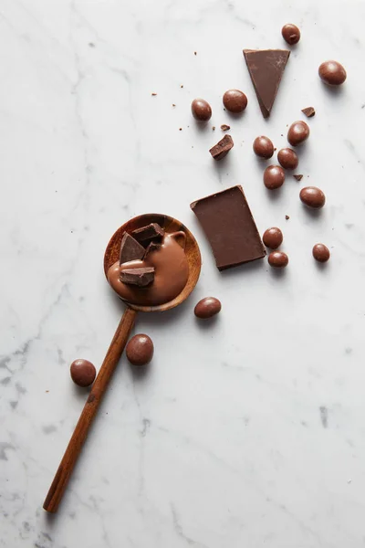 Wooden spoon with chocolate — Stock Photo, Image