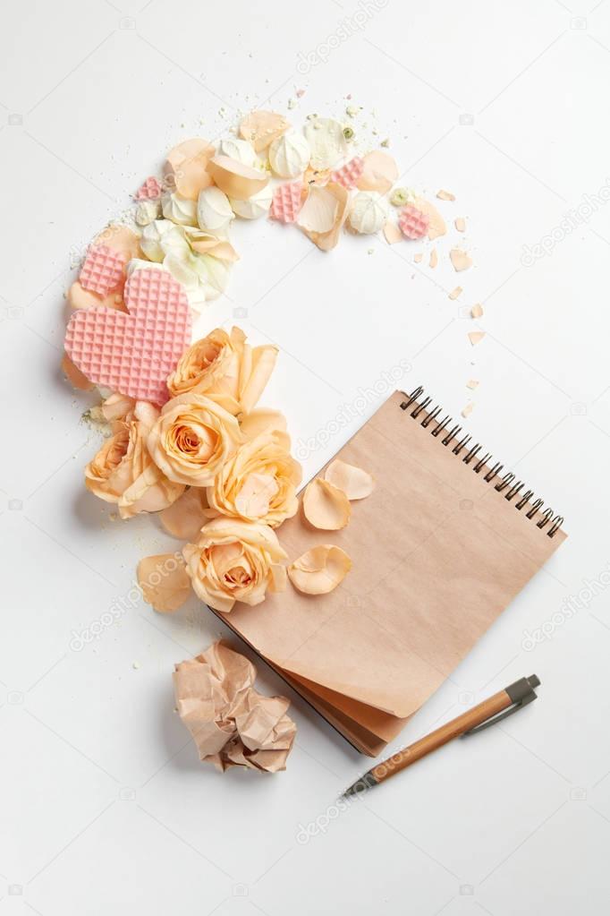 Notepad and roses composition
