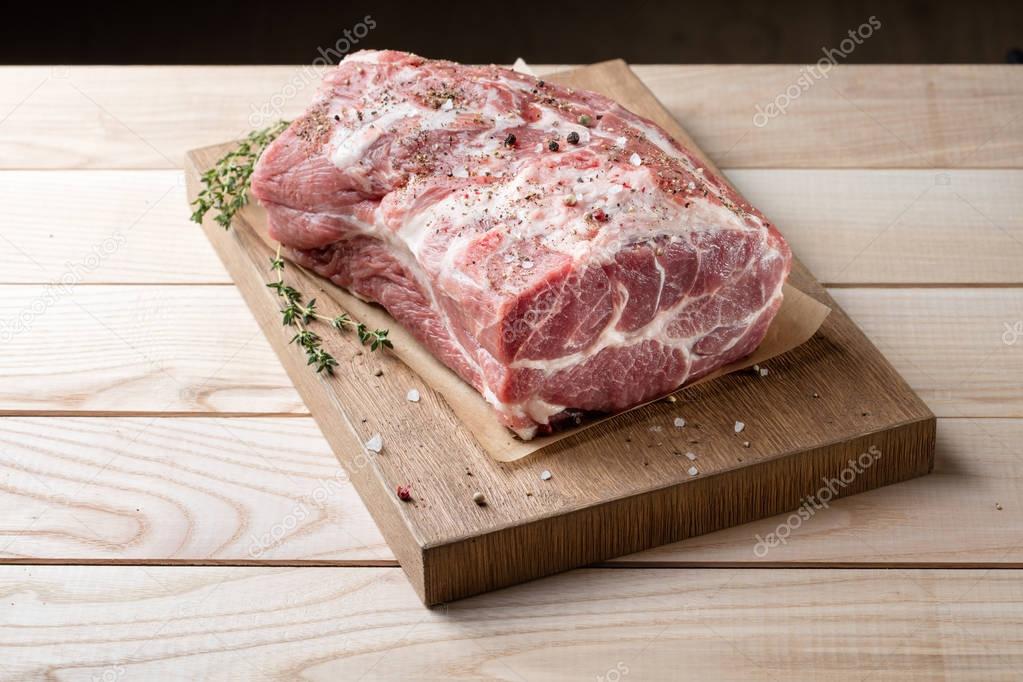 raw meat on wooden board