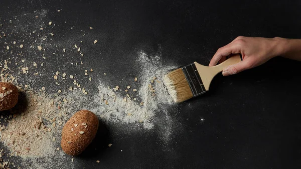 Ręka, zamiatanie mąki z pędzla — Zdjęcie stockowe