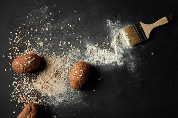 Flour, oatflakes and buns with brush — Stock Photo, Image