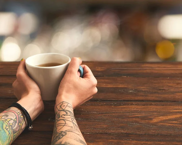 Woman holding hot cup of tea — Stock Photo, Image