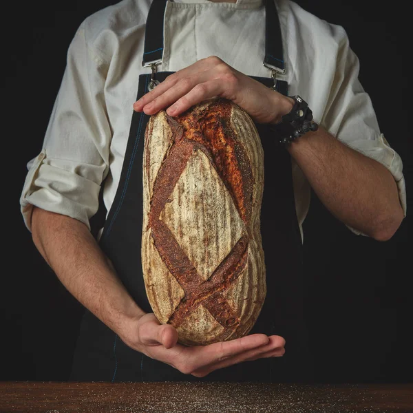 Пекарня в фартусі, що тримає домашній хліб — стокове фото