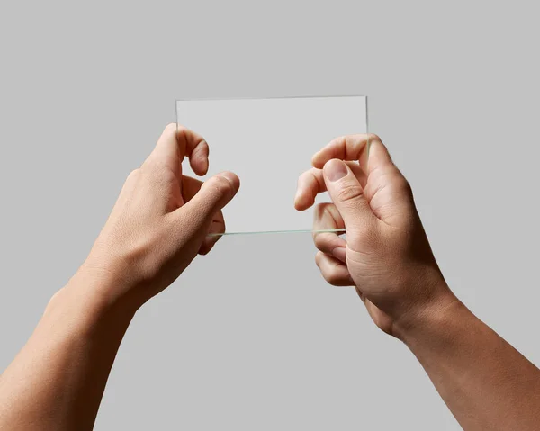 Rectangular transparent glass in male hands — Stock Photo, Image