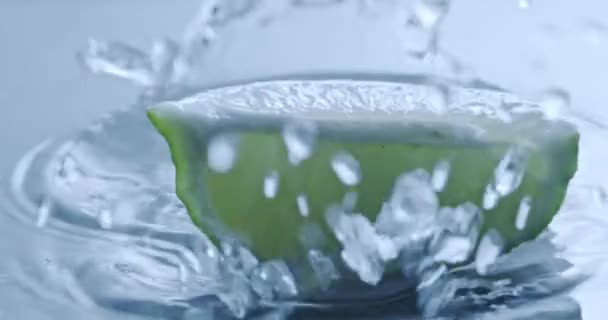 Bit Färsk Lime Faller Blå Bakgrund Med Vatten — Stockvideo